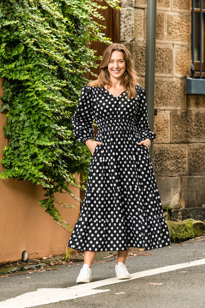 Gorgeous trans-seasonal dress from Boho Australia   We love a little polka dot especially black and white   Featuring a flattering V-Neckline   Smocked elasticated waist   Long sleeves   Maxi length   Inseam pockets   Cotton fabrication 