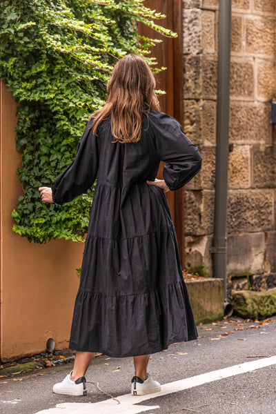 A gorgeous buttoned through Maxi from Boho Australia   Featuring a flattering V-Neckline   Tiered Maxi length skirt with side pockets   A loose relaxed style with long sleeves elasticated cuff  Perfect tran-seasonal maxi that could be cinched in at the waist or worn loosely   100% Cotton fabrication 