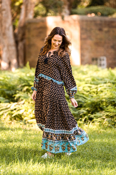 Gorgeous boho style from Boho Australia   Ruffle details on neckline, cuff and waistline   Flattering V-Neckline   Long puff sleeves   Tassel ties and two side inseam pockets   Beautiful print with Black background   Rayon fabrication 